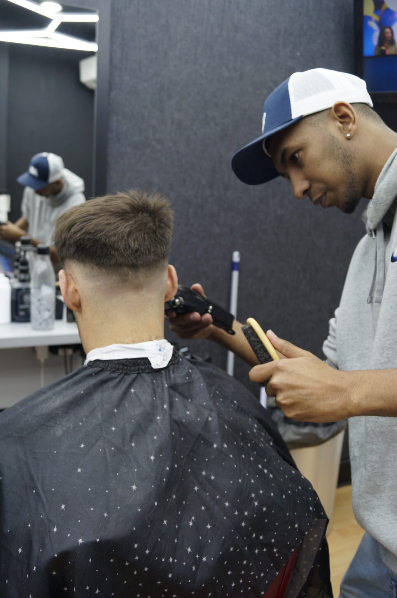 mackenzie giving skin fade to a happy customer