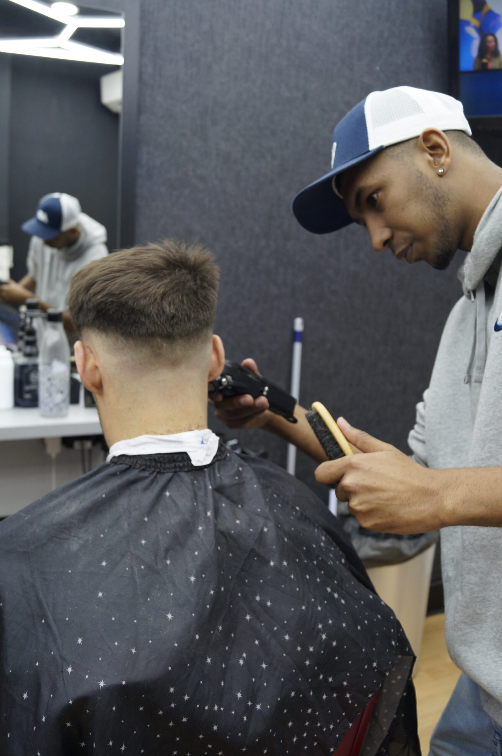 mackenzie giving skin fade to a happy customer